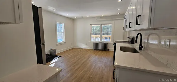 a bathroom with a sink a toilet and a window