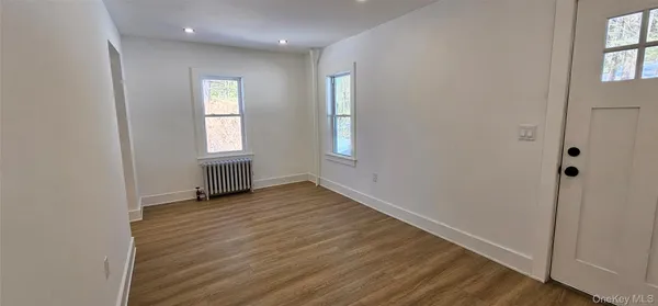 a view of hallway with wooden floor