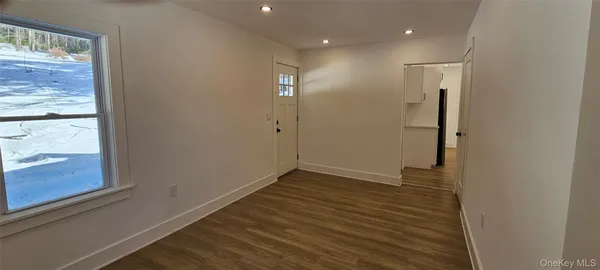 a view of entryway with wooden floor and stairs