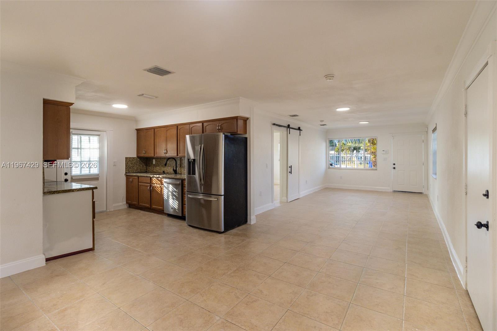 1518 Northwest 65th Street Miami, FL 33147 - Photo 12 of 28 a view of a kitchen with refrigerator microwave and stove
