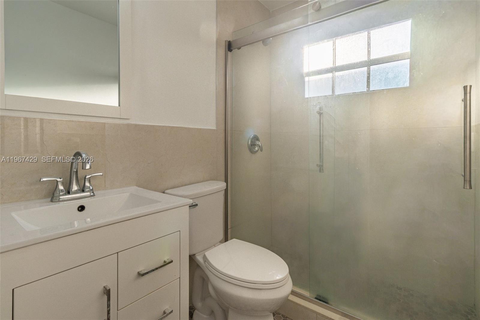 1518 Northwest 65th Street Miami, FL 33147 - Photo 19 of 28 a bathroom with a sink a toilet and shower