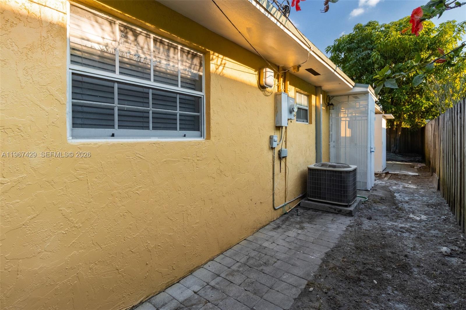 1518 Northwest 65th Street Miami, FL 33147 - Photo 21 of 28 a view of house with backyard and trees