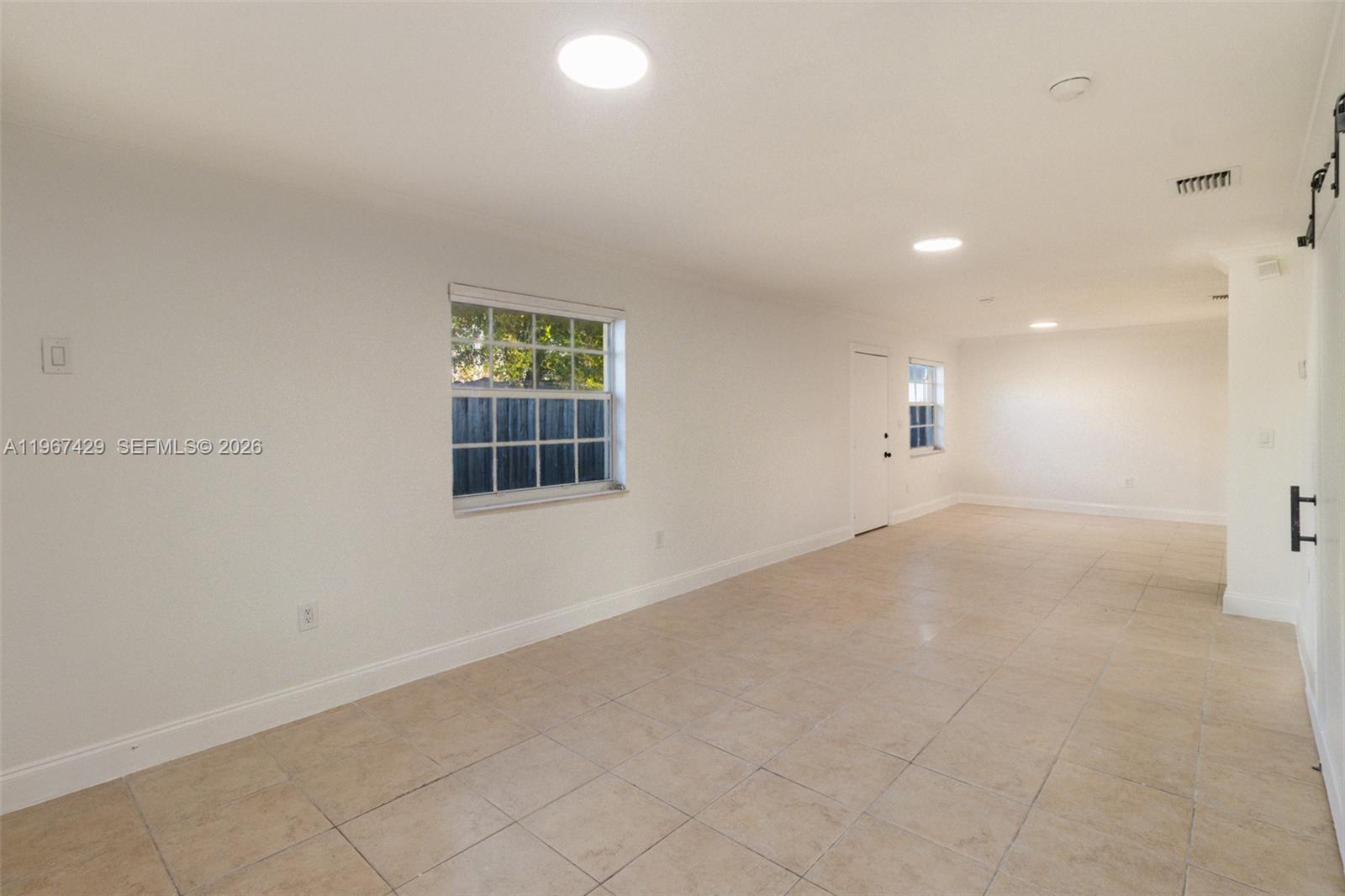 1518 Northwest 65th Street Miami, FL 33147 - Photo 6 of 28 an empty room with windows