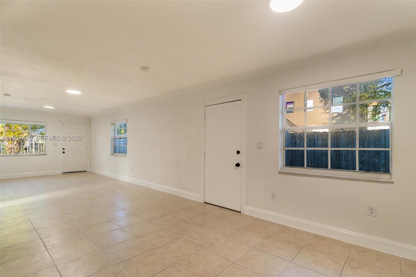 1518 Northwest 65th Street Miami, FL 33147 - Photo 7 of 28 an empty room with windows and closet