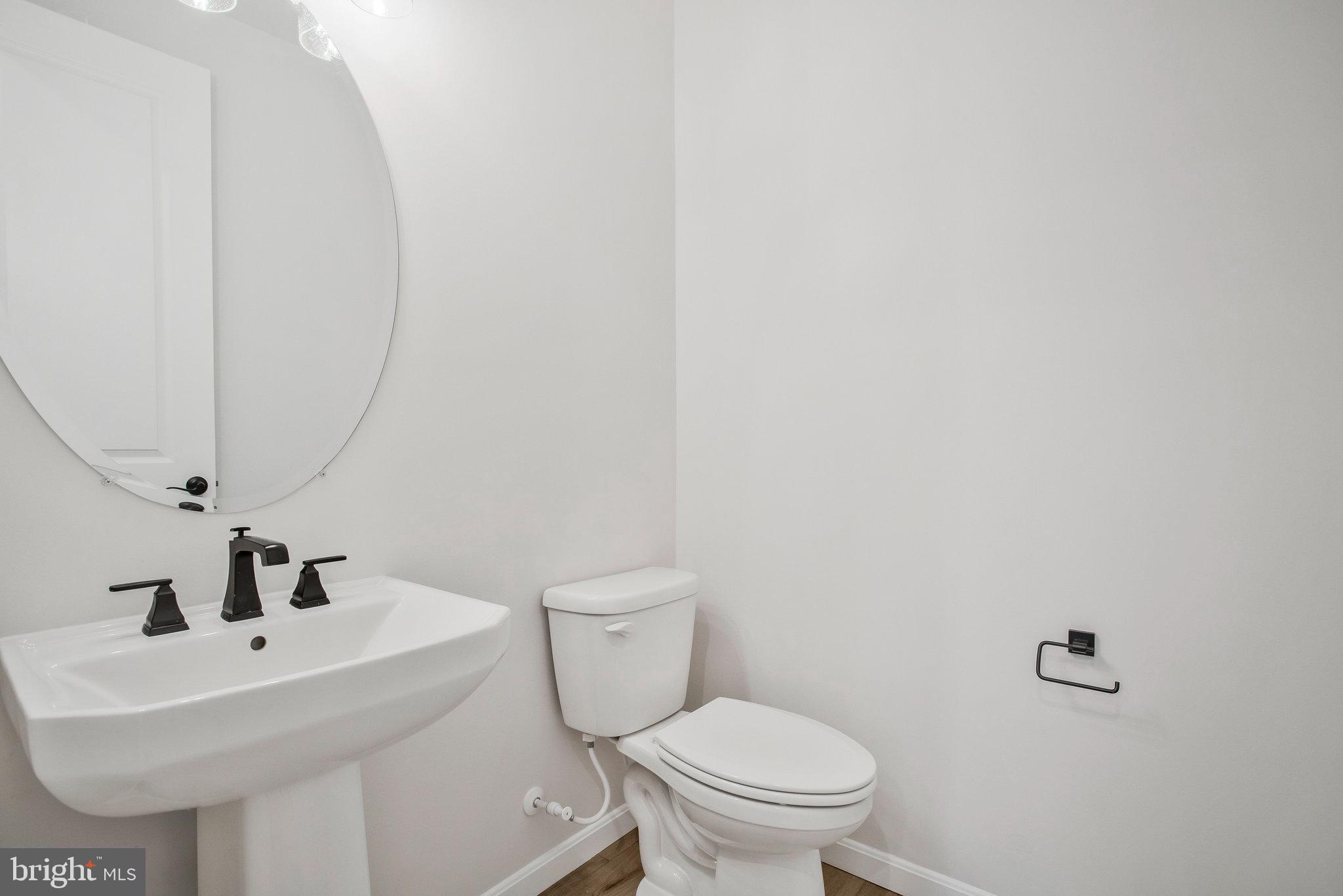 5 Brooks Nolen Way Owings Mills, MD 21117 - Photo 11 of 76 a white toilet sitting next to a white sink