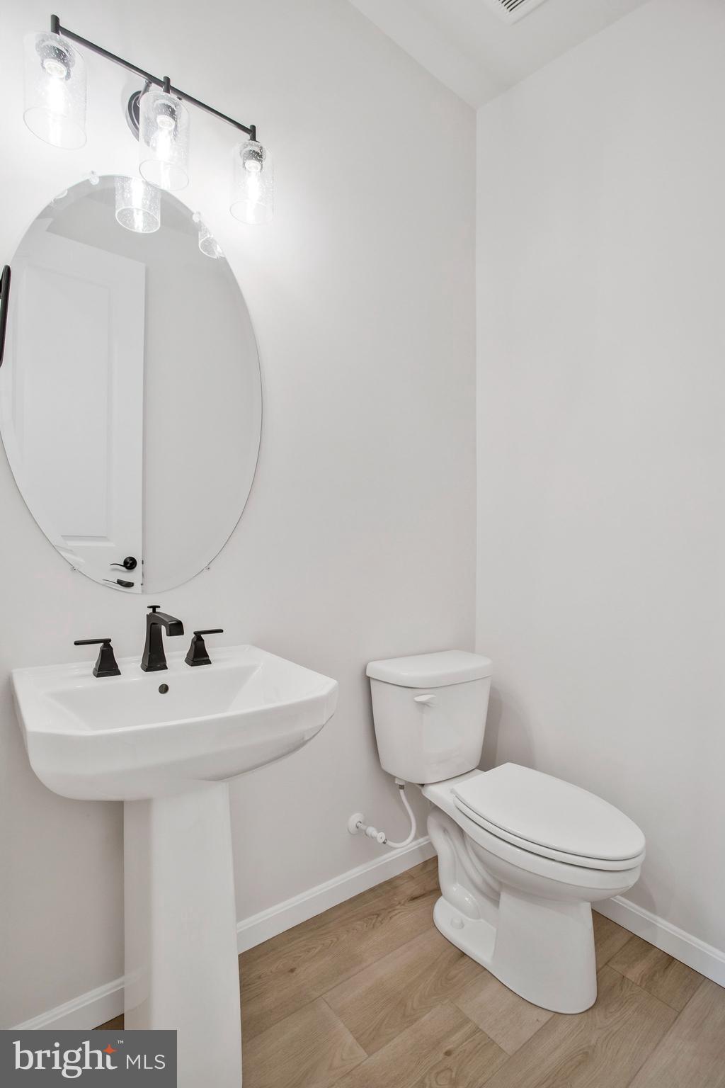 5 Brooks Nolen Way Owings Mills, MD 21117 - Photo 12 of 76 a bathroom with a sink a mirror and toilet