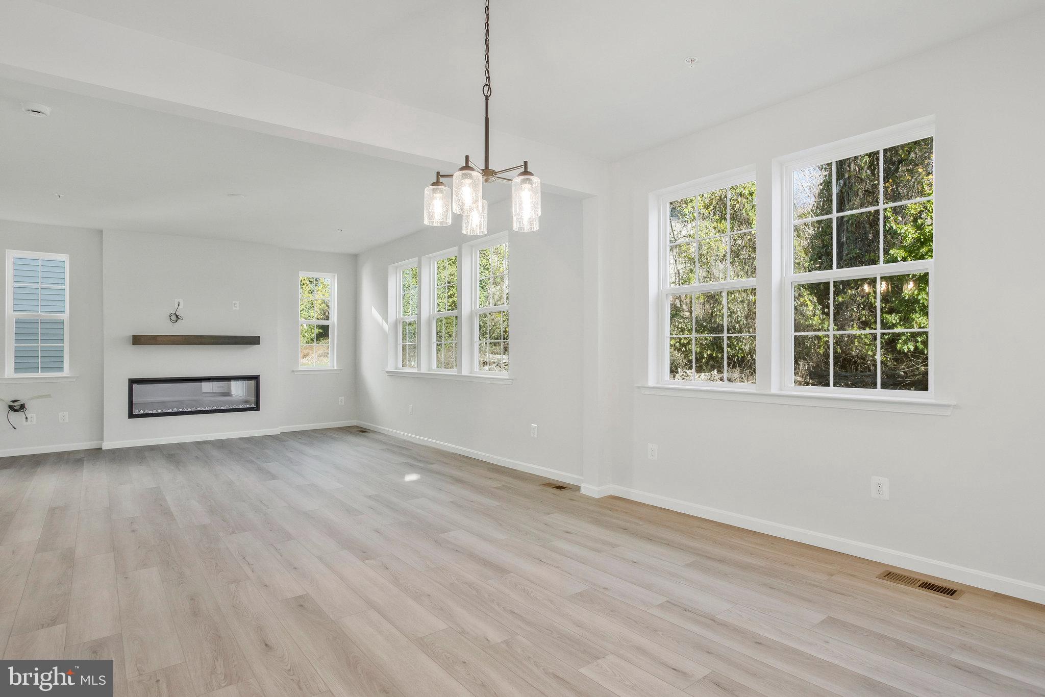5 Brooks Nolen Way Owings Mills, MD 21117 - Photo 20 of 76 an empty room with wooden floor cabinet and windows