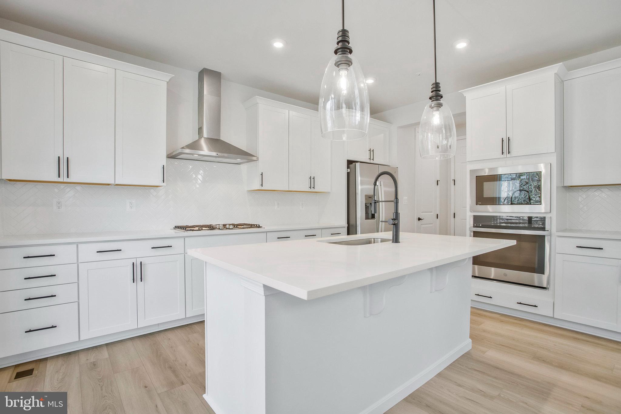 5 Brooks Nolen Way Owings Mills, MD 21117 - Photo 22 of 76 a kitchen with stainless steel appliances granite countertop a sink a stove and a refrigerator