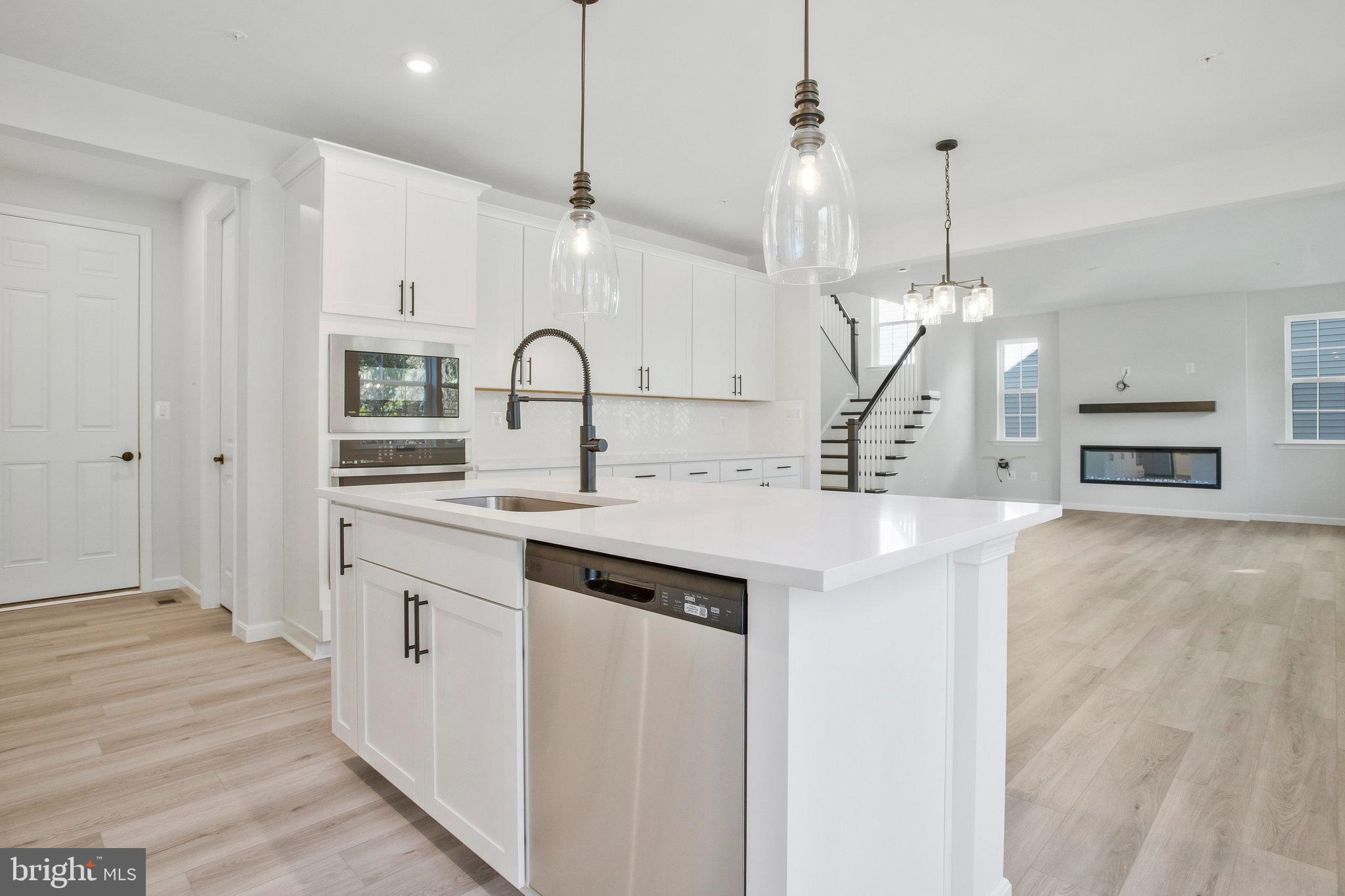 5 Brooks Nolen Way Owings Mills, MD 21117 - Photo 23 of 76 a kitchen with kitchen island a sink appliances and cabinets
