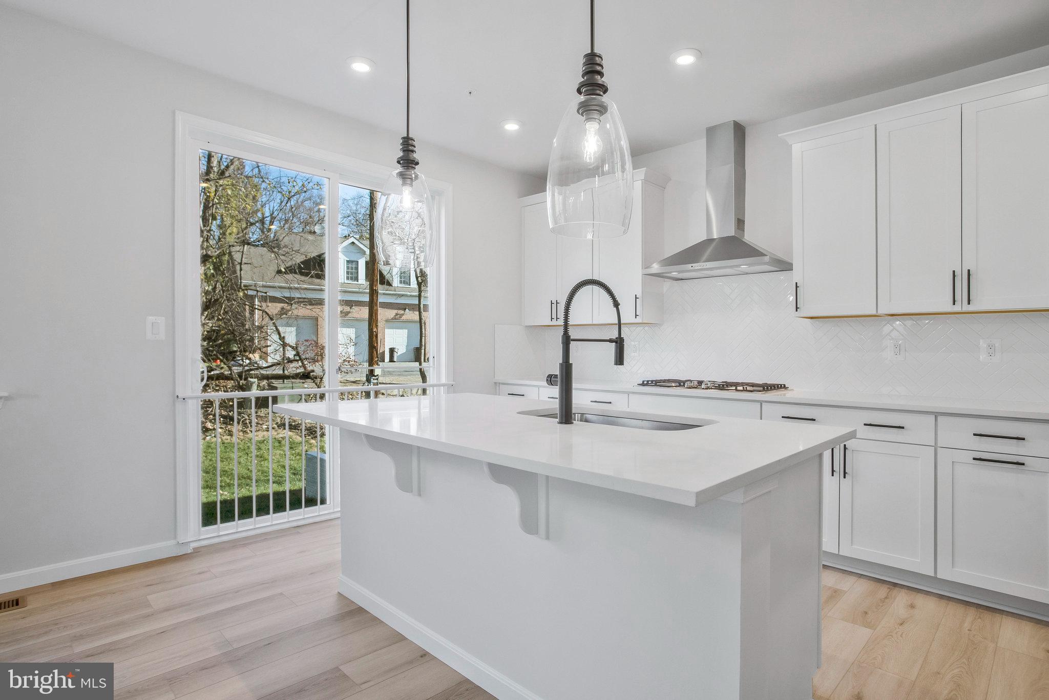 5 Brooks Nolen Way Owings Mills, MD 21117 - Photo 25 of 76 a kitchen with a sink stainless steel appliances and white cabinets