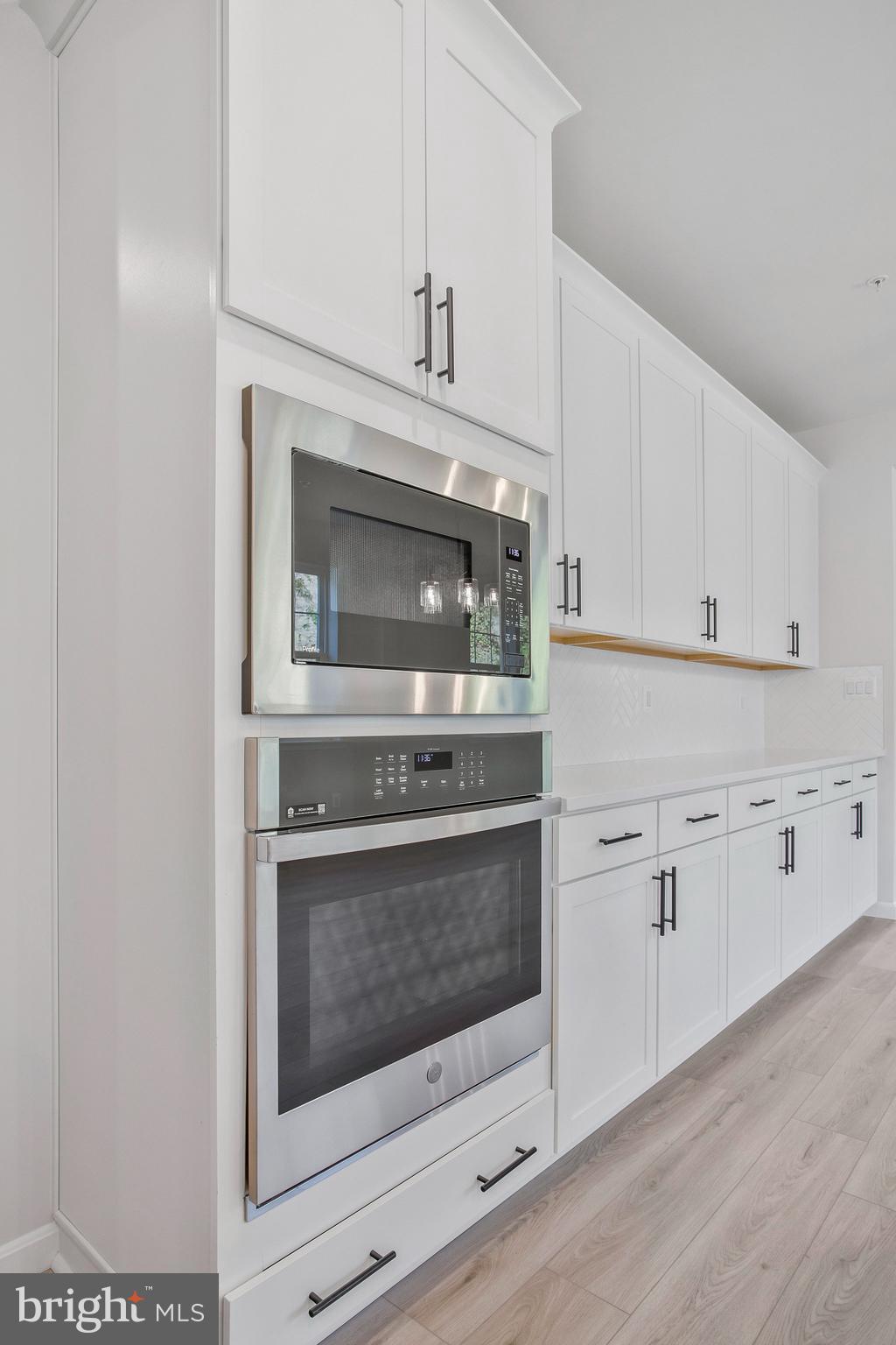 5 Brooks Nolen Way Owings Mills, MD 21117 - Photo 27 of 76 a kitchen with cabinets stainless steel appliances and a sink
