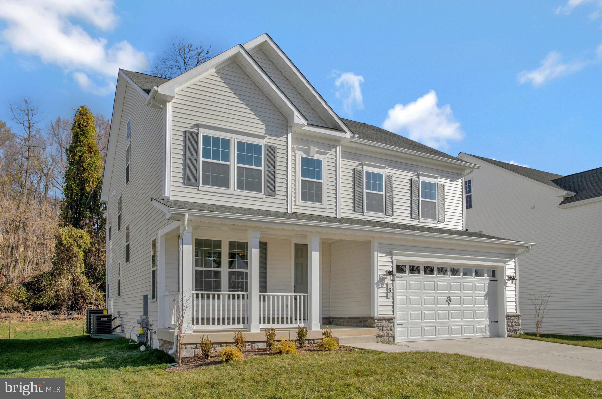 5 Brooks Nolen Way Owings Mills, MD 21117 - Photo 3 of 76 a front view of a house with a yard