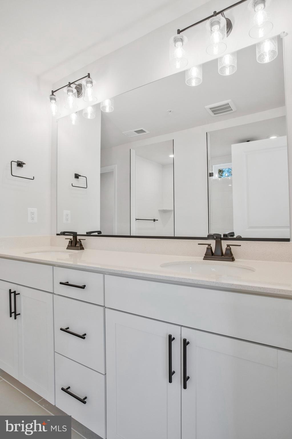 5 Brooks Nolen Way Owings Mills, MD 21117 - Photo 39 of 76 a bathroom with a sink vanity and a mirror
