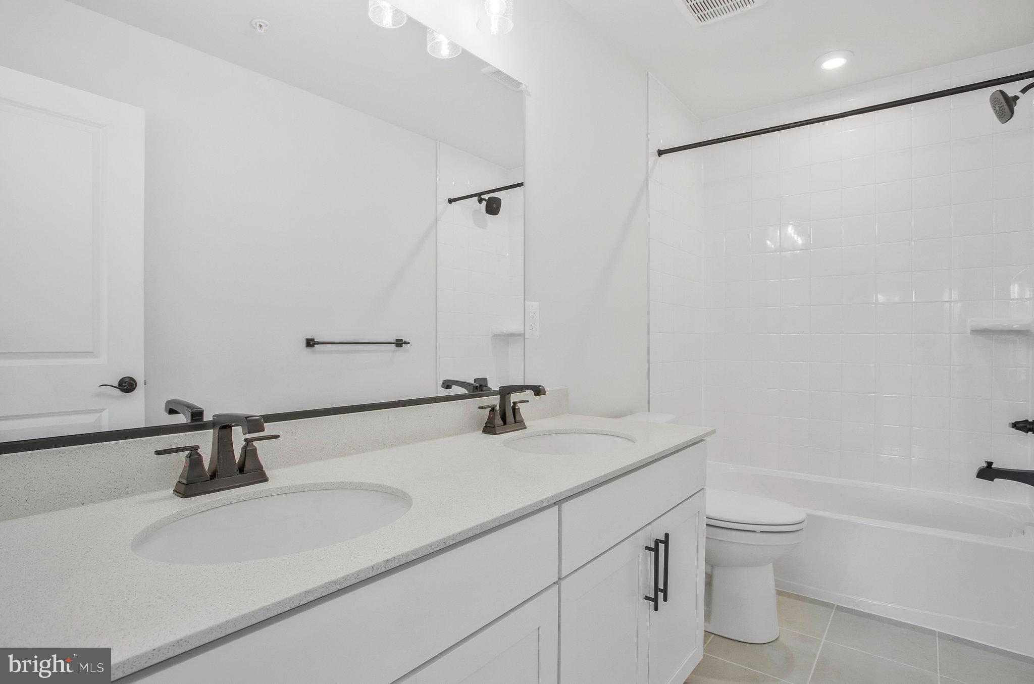 5 Brooks Nolen Way Owings Mills, MD 21117 - Photo 46 of 76 a bathroom with a double vanity sink toilet and a bathtub