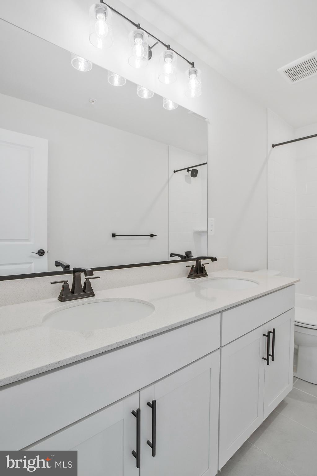 5 Brooks Nolen Way Owings Mills, MD 21117 - Photo 47 of 76 a bathroom with a sink and mirror