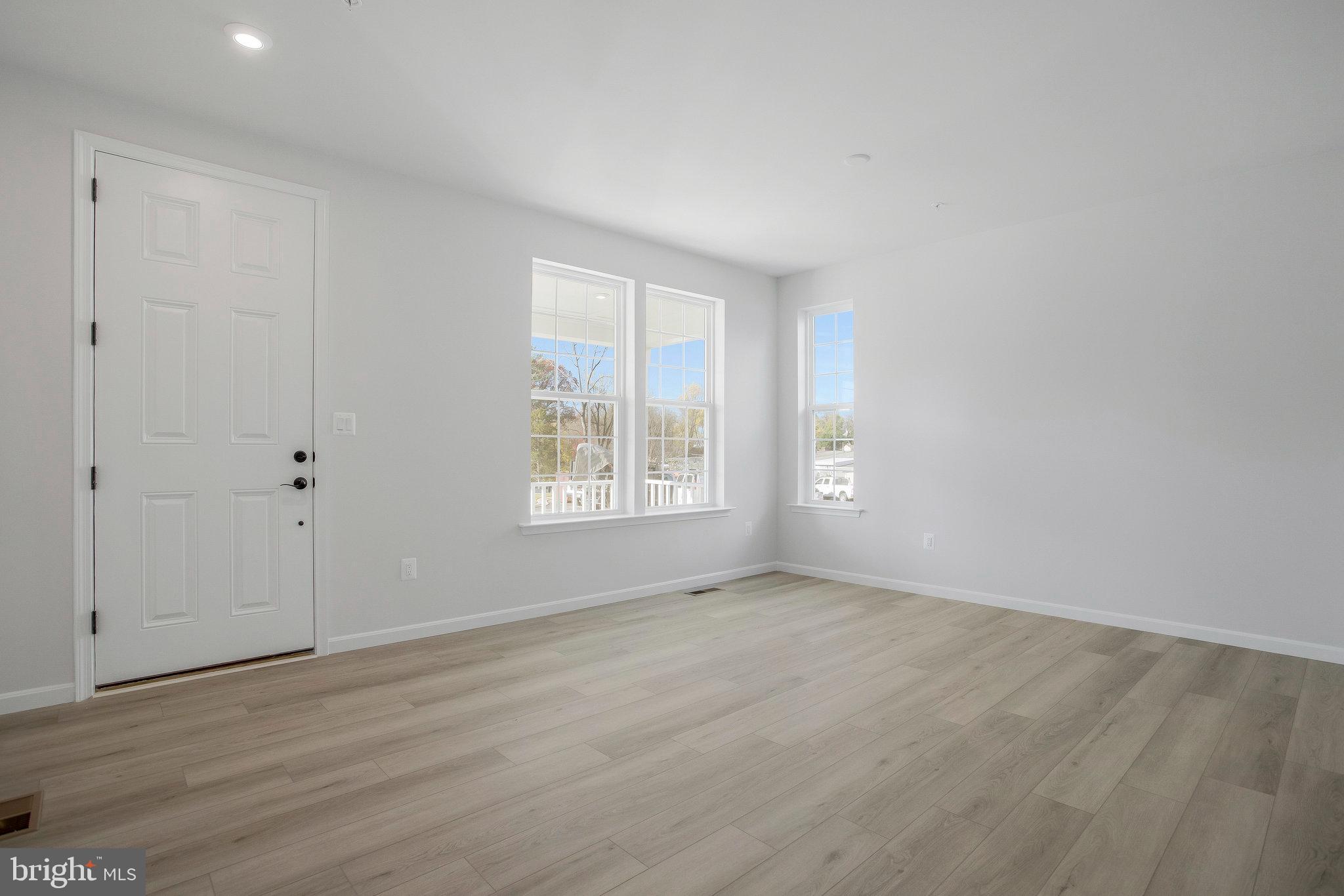 5 Brooks Nolen Way Owings Mills, MD 21117 - Photo 10 of 76 a view of an empty room with wooden floor and a window