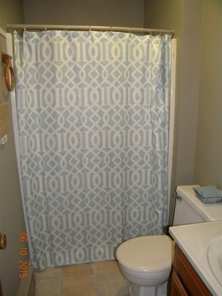 8105 Huber Road Belvidere, IL 61008 - Photo 15 of 20 a white toilet sitting next to a shower curtain