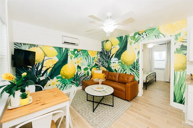 a living room with furniture potted plant and a large mirror