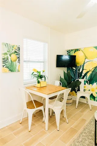 a view of a dining room with furniture and a potted plant