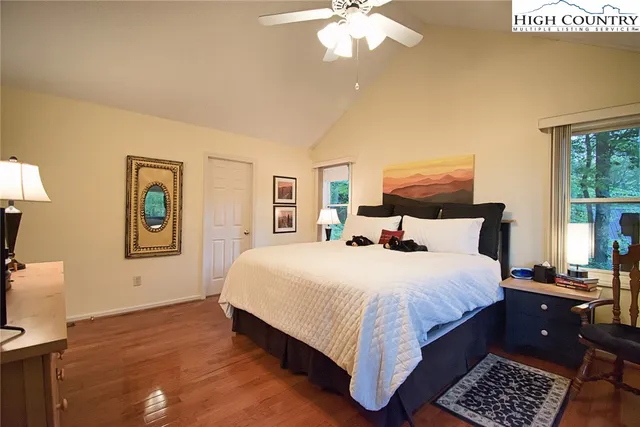 a bedroom with a large bed and a window