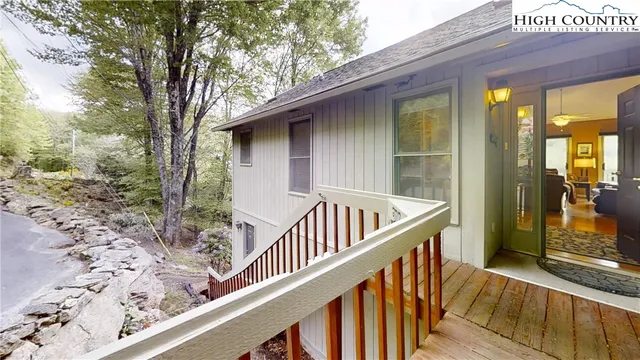 a view of balcony with wooden floor and fence
