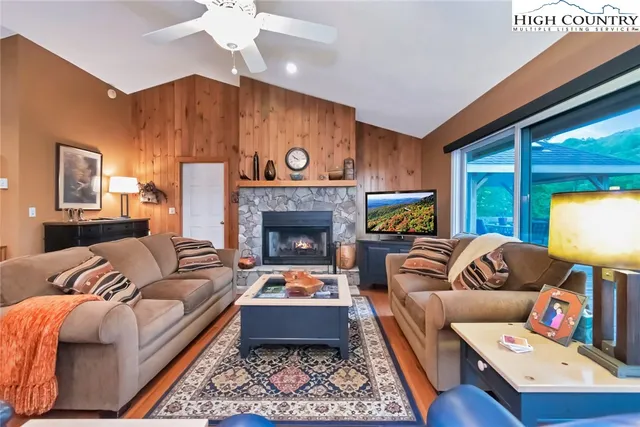 a living room with furniture fireplace and a flat screen tv