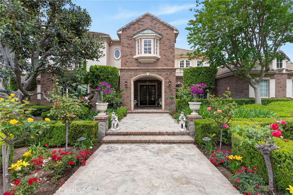 6952 Royal Hunt Ridge Drive Riverside, CA 92506 - Photo 12 of 75 a front view of a house with a yard and flowers