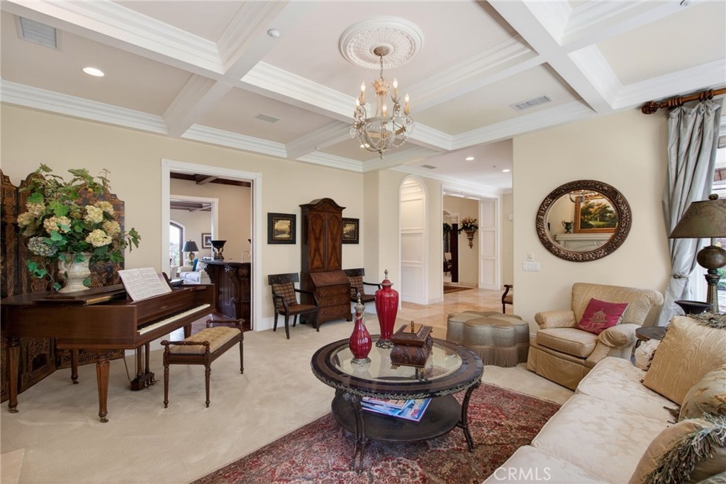 6952 Royal Hunt Ridge Drive Riverside, CA 92506 - Photo 17 of 75 a living room with fireplace furniture and a chandelier