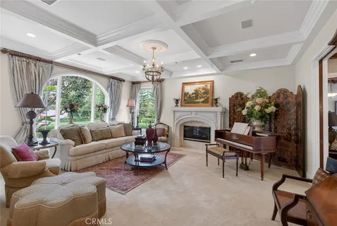 a dining hall with stainless steel appliances granite countertop a refrigerator a sink a dining table and chairs