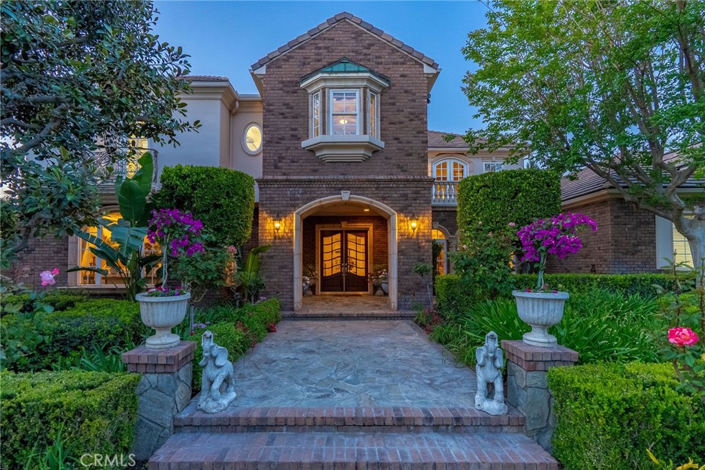 6952 Royal Hunt Ridge Drive Riverside, CA 92506 - Photo 2 of 75 a front view of a house with a garden