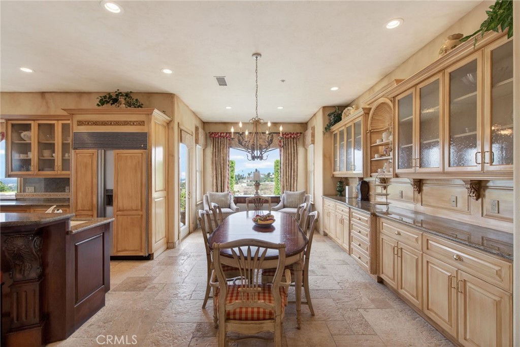6952 Royal Hunt Ridge Drive Riverside, CA 92506 - Photo 28 of 75 a large kitchen with a table and chairs