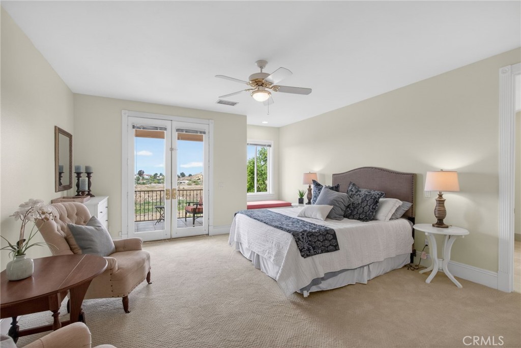 6952 Royal Hunt Ridge Drive Riverside, CA 92506 - Photo 43 of 75 a spacious bedroom with a bed and a couch