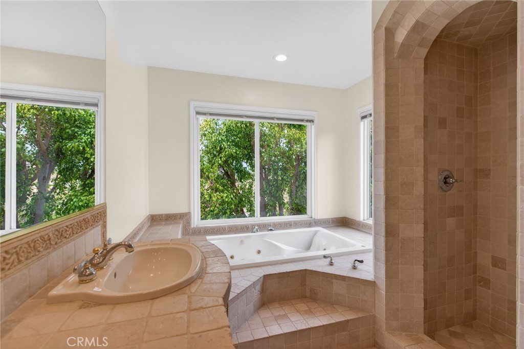 6952 Royal Hunt Ridge Drive Riverside, CA 92506 - Photo 45 of 75 a bathroom with a tub a sink and a window