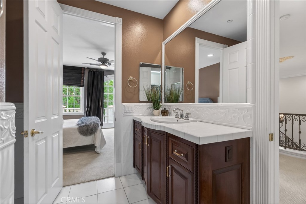 6952 Royal Hunt Ridge Drive Riverside, CA 92506 - Photo 46 of 75 a bathroom with a sink a vanity and a mirror