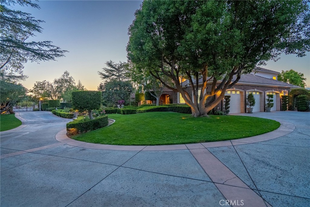 6952 Royal Hunt Ridge Drive Riverside, CA 92506 - Photo 61 of 75 a front view of a house with a yard and trees
