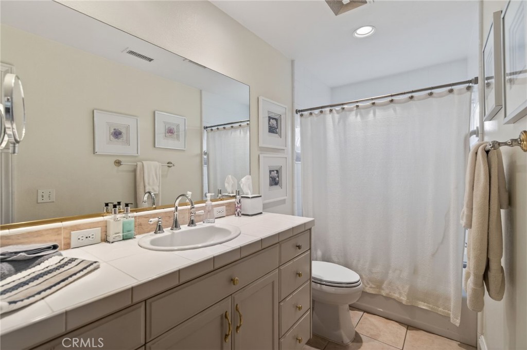 6952 Royal Hunt Ridge Drive Riverside, CA 92506 - Photo 71 of 75 a bathroom with a sink toilet double vanity and shower