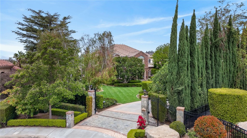 6952 Royal Hunt Ridge Drive Riverside, CA 92506 - Photo 8 of 75 a view of a street with potted plants and large trees