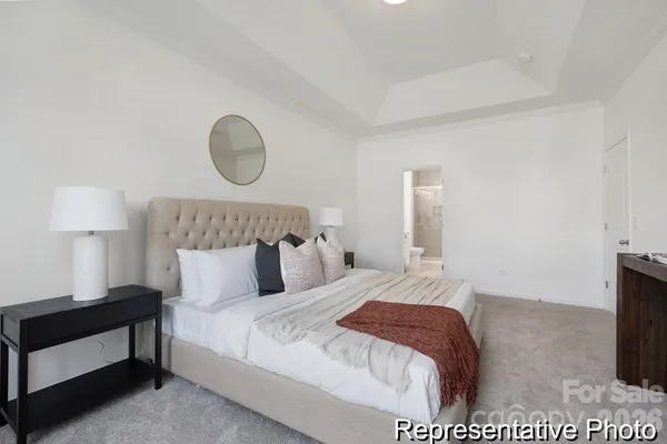 a bedroom with a bed and a lamp on table