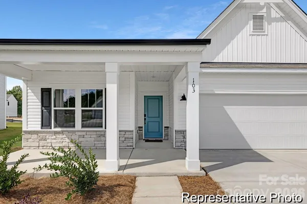a front view of a house with a blue gate