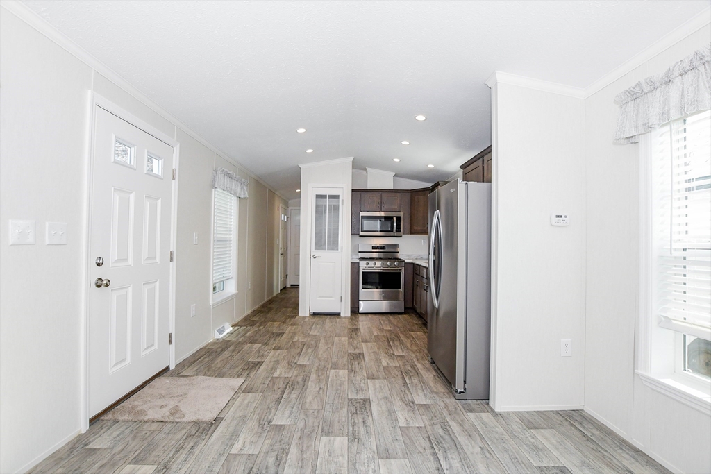 3040 Cranberry Highway, Unit 32 Wareham, MA 02538 - Photo 12 of 25 a view of kitchen with wooden floor electronic appliances and window