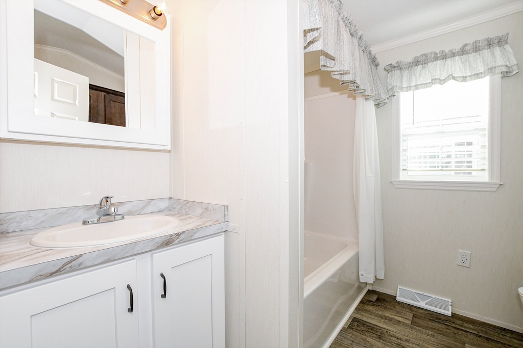 3040 Cranberry Highway, Unit 32 Wareham, MA 02538 - Photo 16 of 25 a bathroom with a sink and a mirror