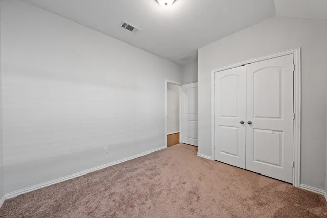 a view of an empty room and entryway