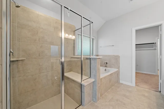 a bathroom with a bathtub and a shower