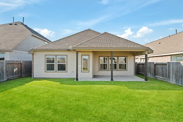 a view of a house with a yard and sitting area