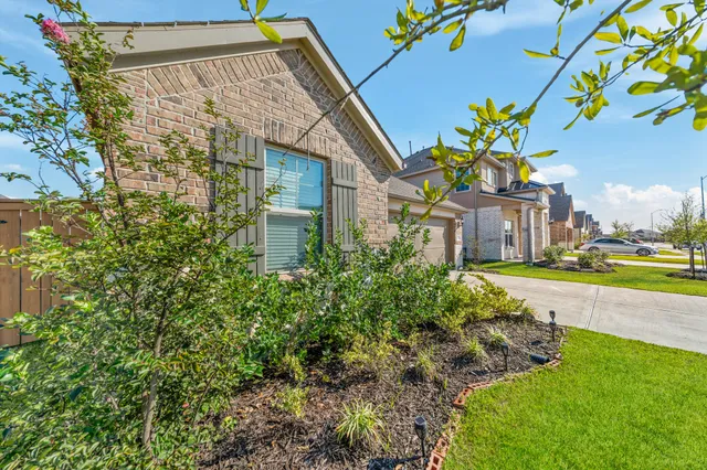 a front view of a house with a yard and fountain