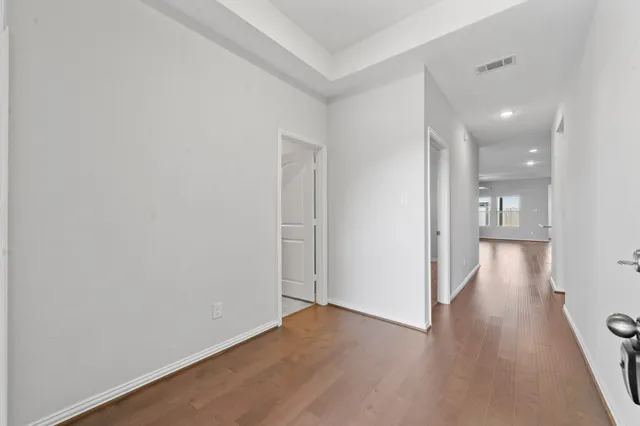 a view of hallway with wooden floor