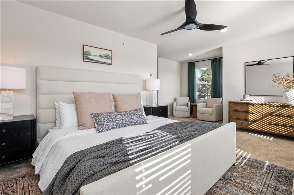 11535 Kimberly Court Hampton, GA 30228 - Photo 22 of 29 a bedroom with a large bed and a chandelier