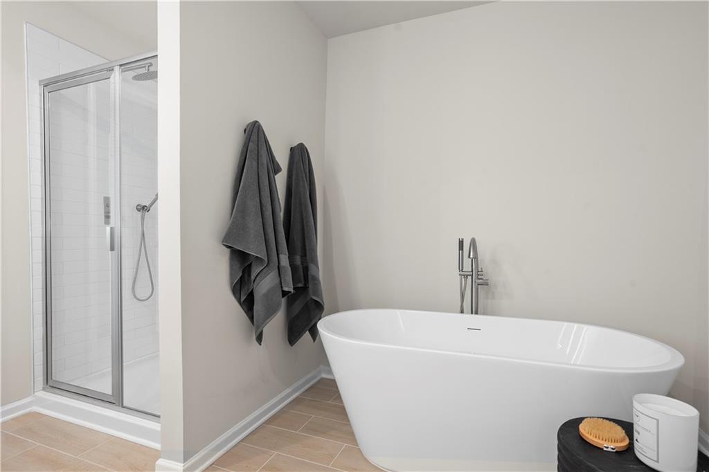 11535 Kimberly Court Hampton, GA 30228 - Photo 24 of 29 a bathroom with a bathtub and a shower