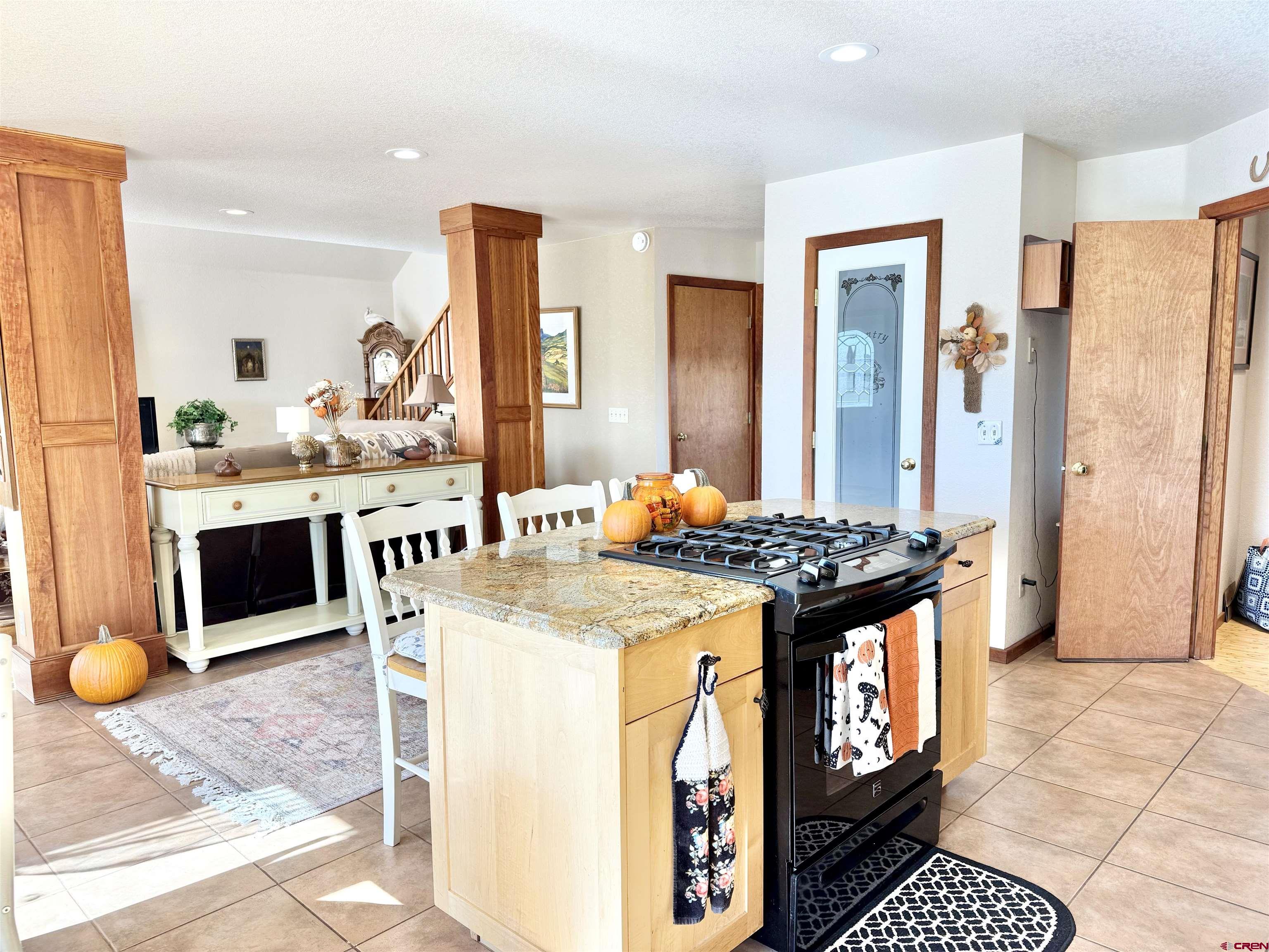 10528 Bostwick Park Road Montrose, CO 81401 - Photo 12 of 43 a kitchen with stainless steel appliances granite countertop a stove and a refrigerator