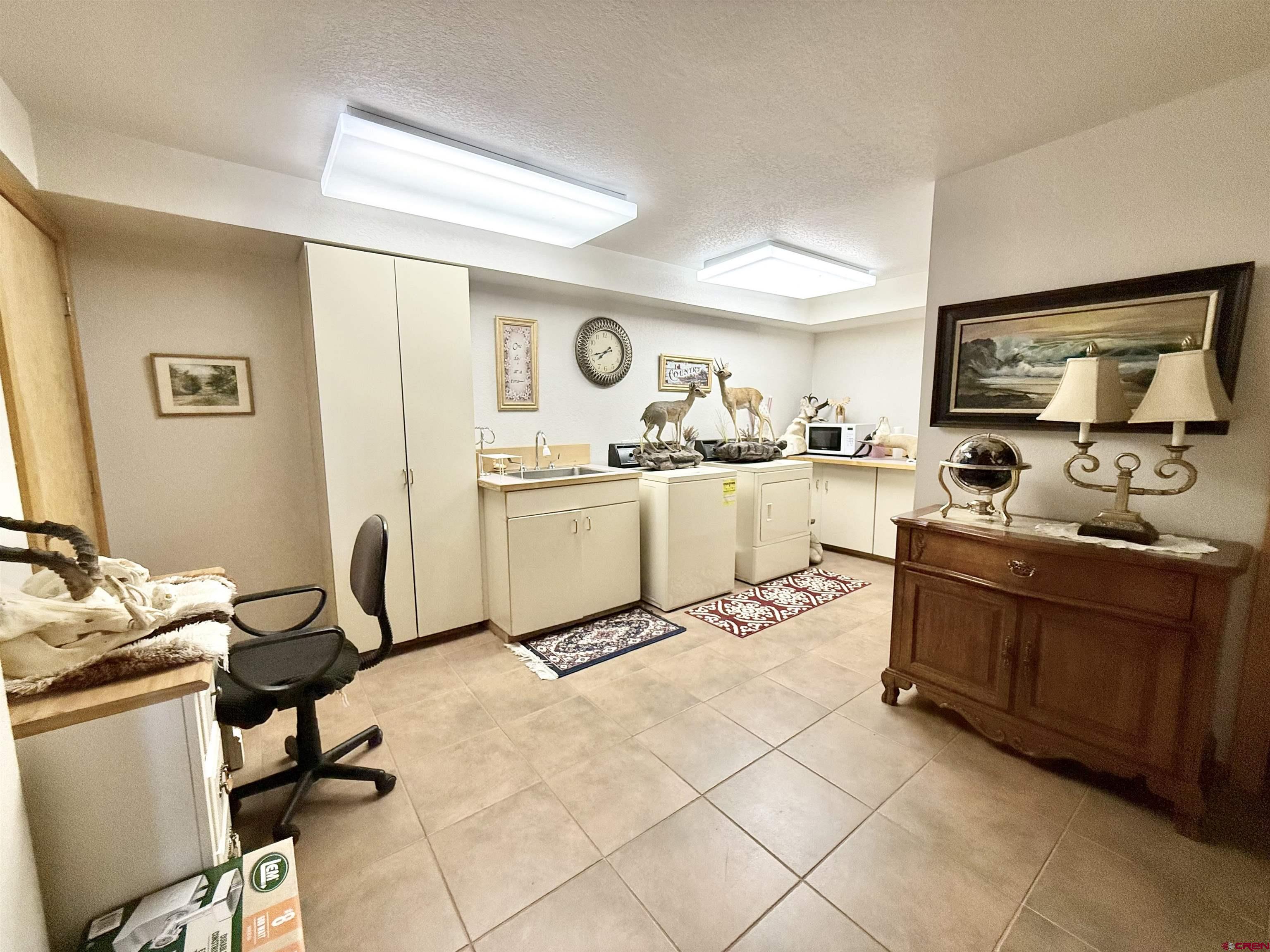 10528 Bostwick Park Road Montrose, CO 81401 - Photo 24 of 43 a kitchen with a sink appliances and cabinets